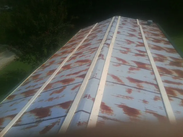 Rusted metal roof panels with new wood purlins before replacement — Storm Damage Roof Repair in Millersville by Roofing Brothers